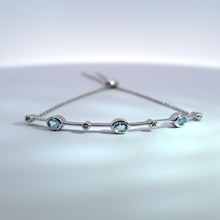 Load image into Gallery viewer, Rhodium Plated Sterling Silver Oval Blue Topaz &amp; White Sapphire Station Bar &amp; Chain Bolo Bracelet
